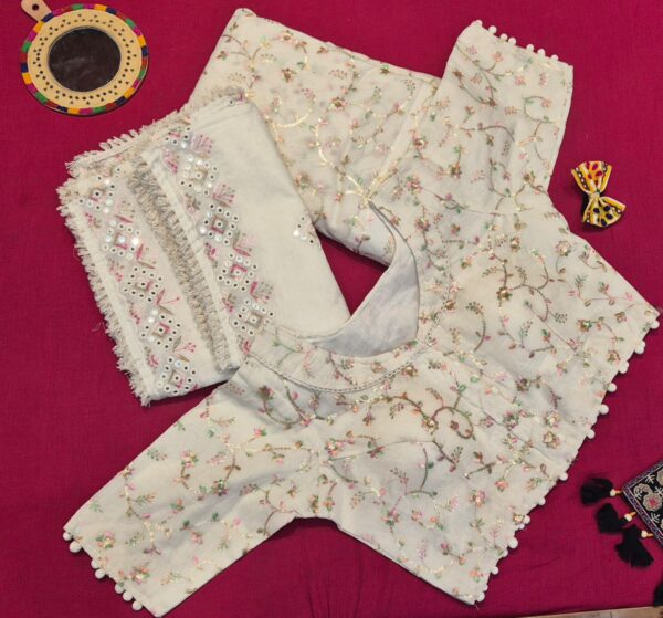 Elegant ivory lehenga choli set featuring delicate floral embroidery and mirror work